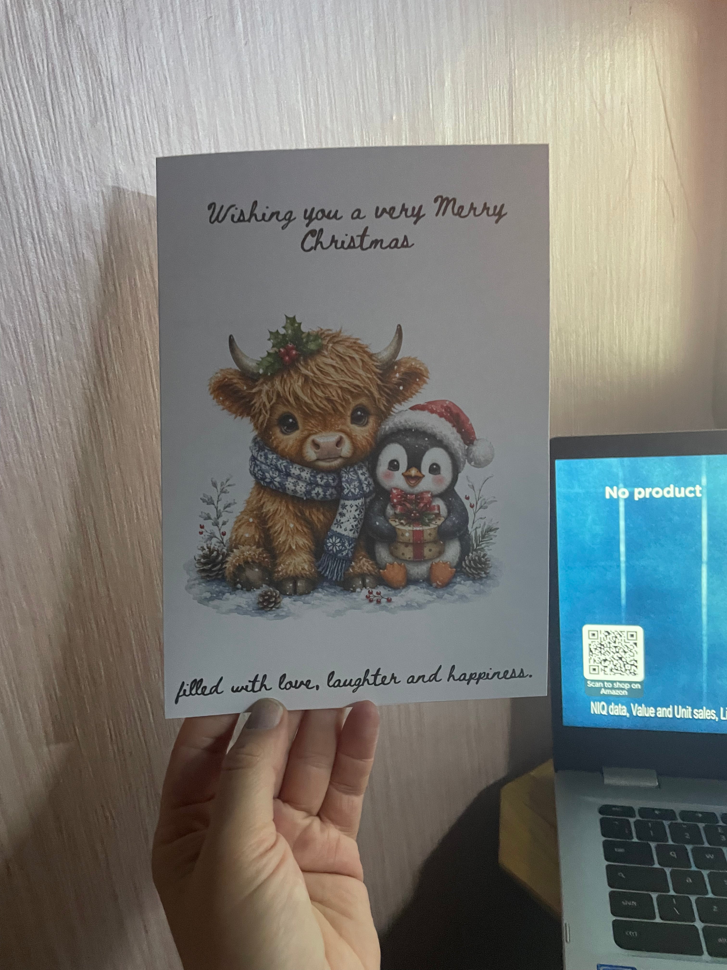 Festive highland cow and penguin Christmas card