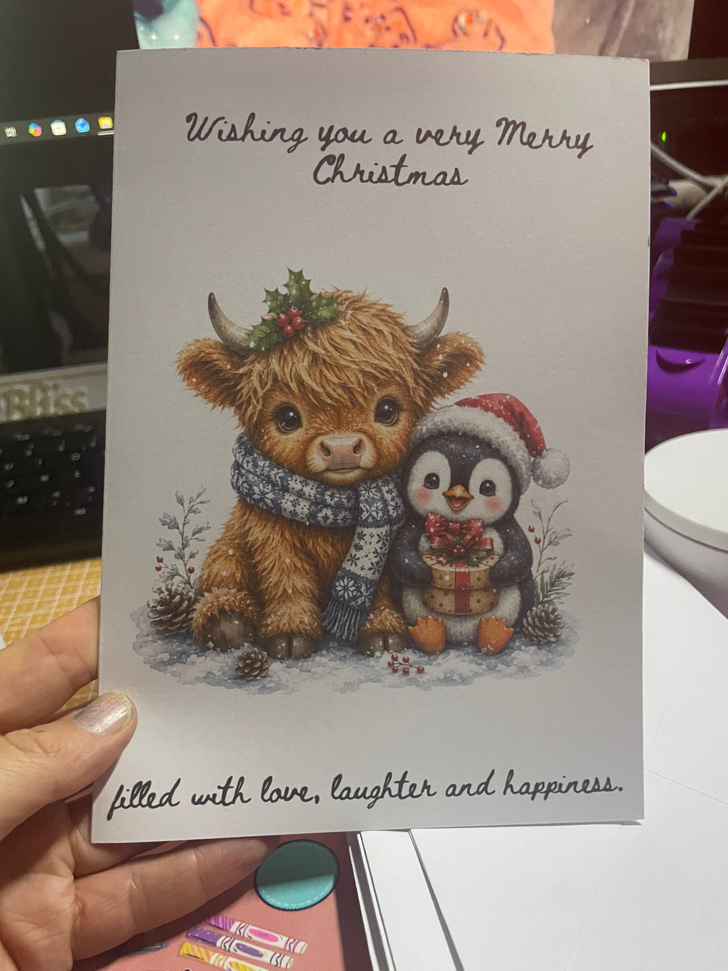 Festive highland cow and penguin Christmas card