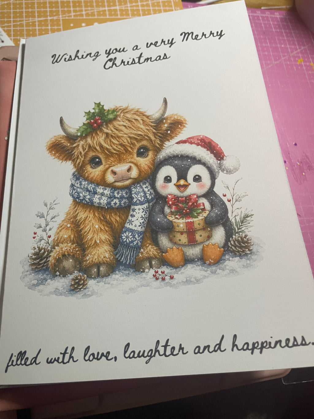 Festive highland cow and penguin Christmas card